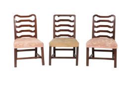 A GROUP OF THREE GEORGE III MAHOGANY LADDERBACK DINING CHAIRS