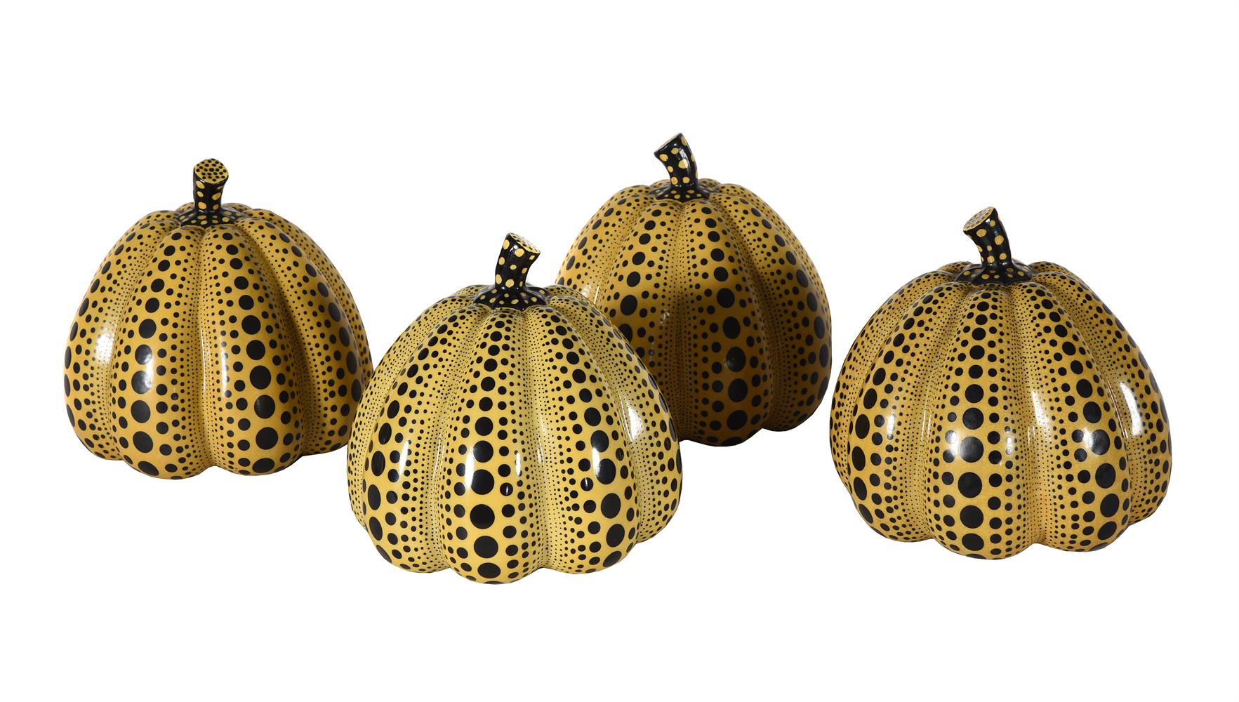 A SET OF FOUR YELLOW GLASS AND BLACK ENAMELLED MODELS OF PUMPKINS AFTER YAYOKI KUSAMA