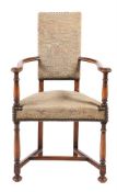 A WALNUT AND TAPESTRY UPHOLSTERED OPEN ARMCHAIR