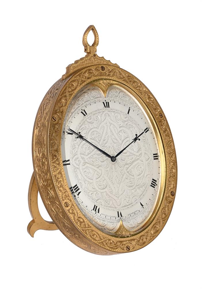 A FINE ENGRAVED GILT BRASS STRUT TIMEPIECE IN THE MANNER OF THOMAS COLE