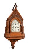 AN IMPRESSIVE VICTORIAN CARVED OAK GOTHIC REVIVAL BRACKET CLOCK WITH WALL BRACKET