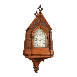 AN IMPRESSIVE VICTORIAN CARVED OAK GOTHIC REVIVAL BRACKET CLOCK WITH WALL BRACKET