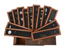 AN UNUSUAL CASED SET OF ENGLISH HAND PAINTED GLASS EDUCATIONAL ASTRONOMICAL MAGIC LANTERN SLIDES