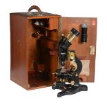 A BLACK JAPANNED AND LACQUERED BRASS ‘PATNA’ COMPOUND BINOCULAR MICROSCOPE