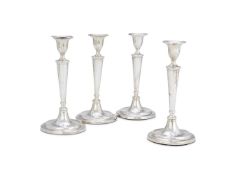 A SET OF FOUR GEORGE III SILVER CANDLESTICKS