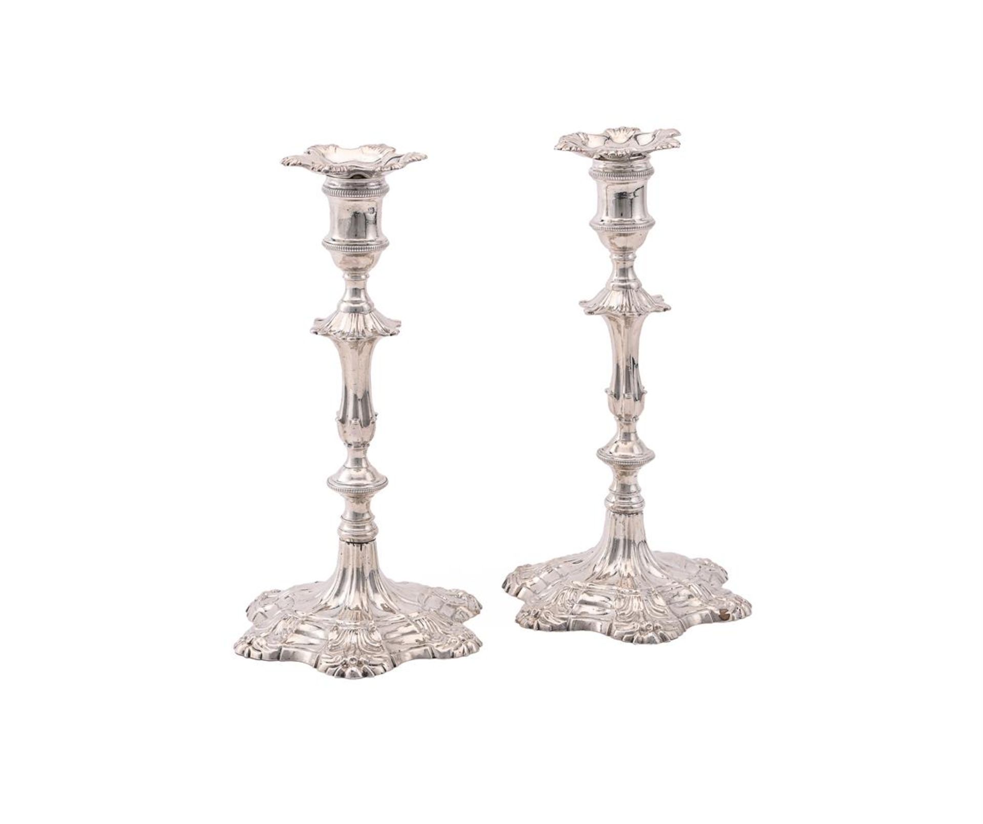 A PAIR OF GEORGE II CAST SILVER CANDLESTICKS