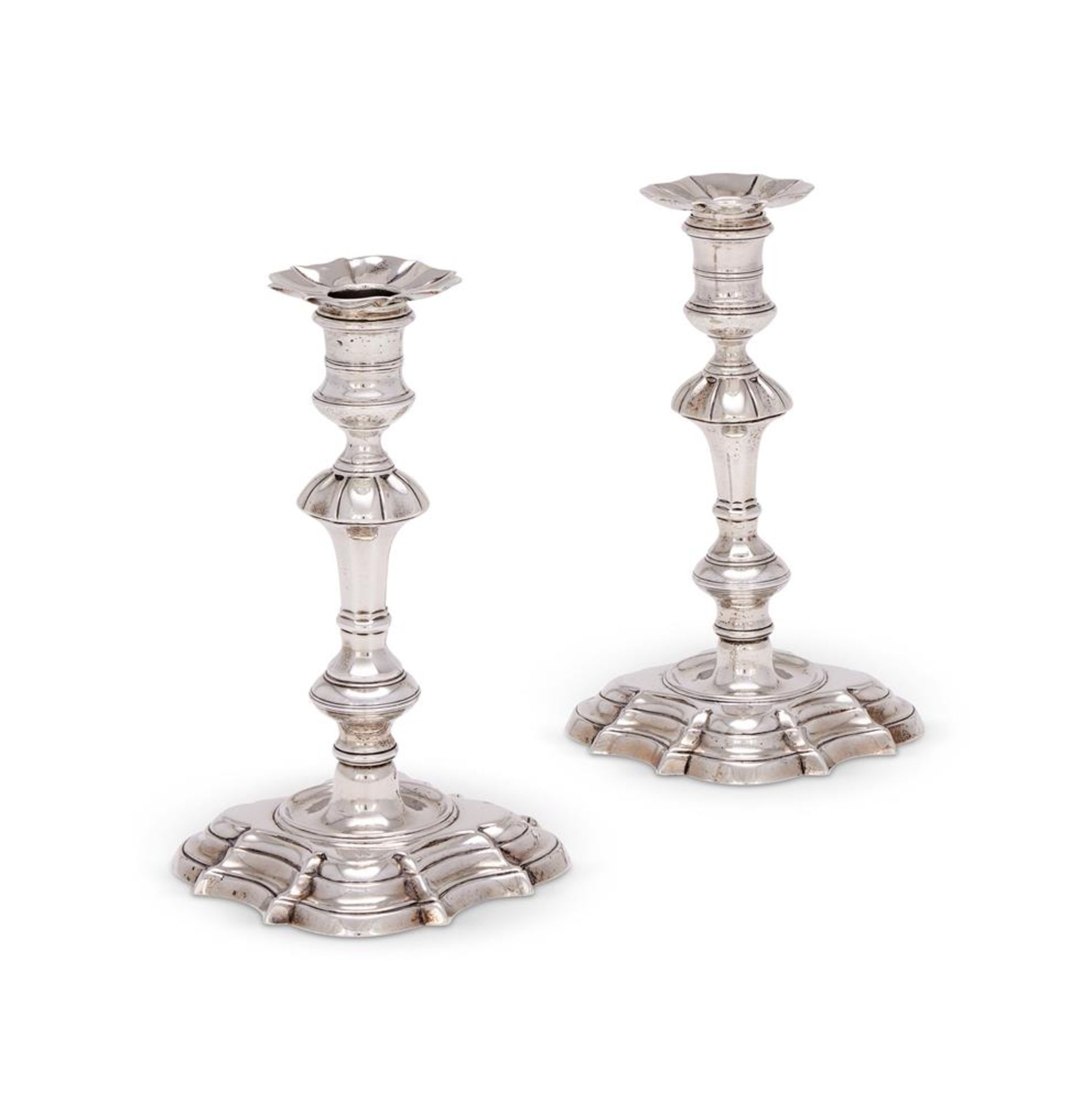 A MATCHED PAIR OF GEORGE II CAST SILVER CANDLESTICKS