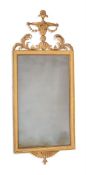 A GEORGE III CARVED GILTWOOD WALL MIRROR, IN THE MANNER OF ROBERT ADAM, CIRCA 1790