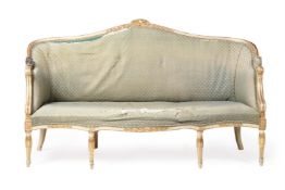 A GEORGE III CREAM PAINTED AND PARCEL GILT SOFA, IN THE MANNER OF DESIGNS BY LINNELL, CIRCA 1780