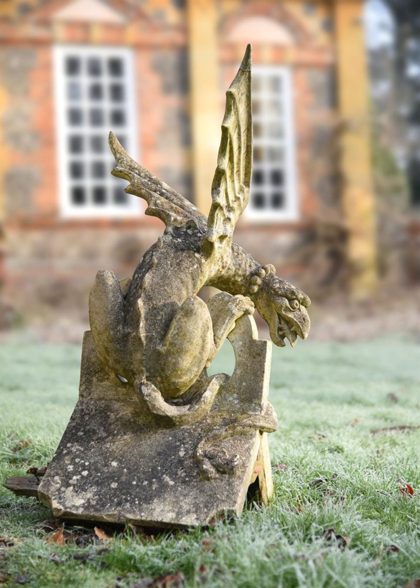 A COMPOSITION STONE GRIFFIN RIDGE TILE FINIAL, LATE 19TH CENTURY