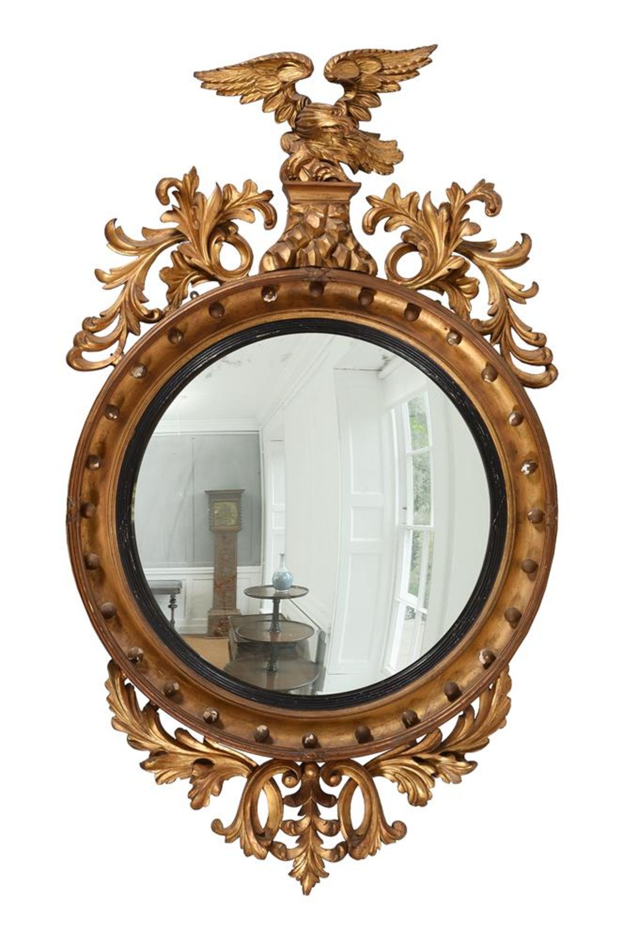 A LARGE REGENCY CARVED GILTWOOD CONVEX WALL MIRROR, IN THE MANNER OF THOMAS FENTHAM, CIRCA 1815