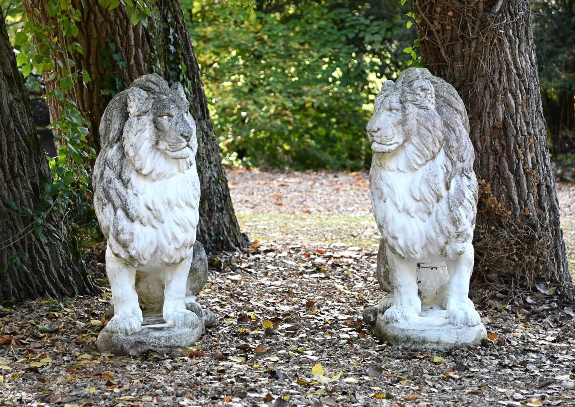 A LARGE PAIR OF COMPOSITION STONE SEATED LIONS, 20TH CENTURY