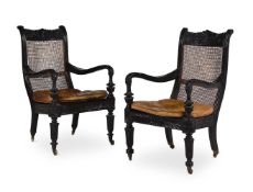 Y A NEAR PAIR OF ANGLO INDIAN CARVED EBONY ARMCHAIRS, MID 19TH CENTURY