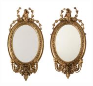 A PAIR OF VICTORIAN GILTWOOD AND GESSO OVAL GIRANDOLE MIRRORS