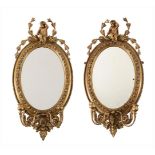 A PAIR OF VICTORIAN GILTWOOD AND GESSO OVAL GIRANDOLE MIRRORS