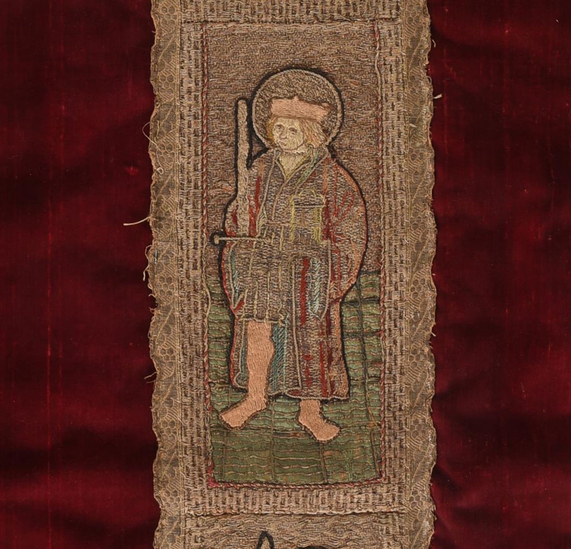 A CHASUBLE FRAGMENT, THE RED VELVET FIELD WITH EARLIER ORPHREY WOVEN WITH THREE SAINTS - Image 2 of 4