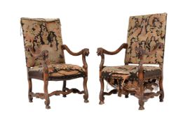 A PAIR OF CARVED WALNUT AND UPHOLSTERED OPEN ARMCHAIRS IN CONTINENTAL EARLY 18TH CENTURY TASTE