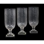 A SET OF THEE CLEAR GLASS STORM VASES