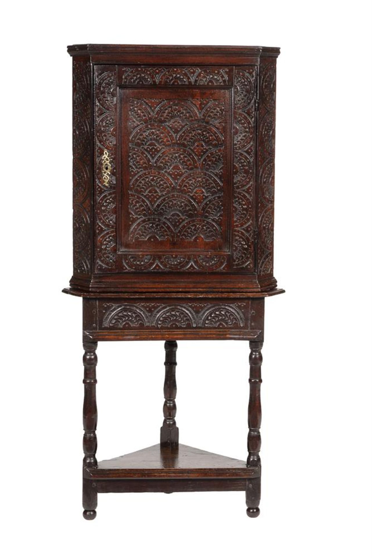 A CARVED OAK CORNER CABINET ON STAND