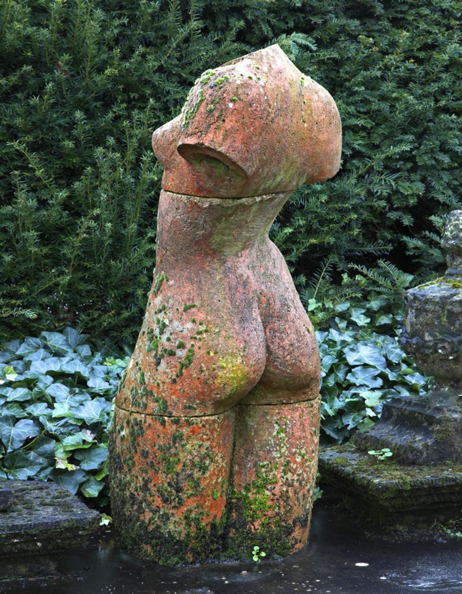 λ Ω A TERRACOTTA MODEL OF THE TORSO OF A WOMAN