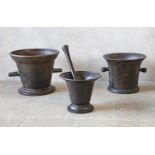 ‡ A GROUP OF THREE CAST IRON MORTARS