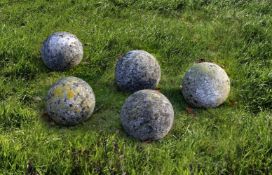 ‡ A GROUP OF FIVE LIMESTONE ORNAMENTAL SPHERES