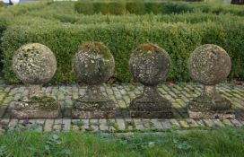 ‡ A SET OF FOUR CARVED LIMESTONE PIER FINIALS