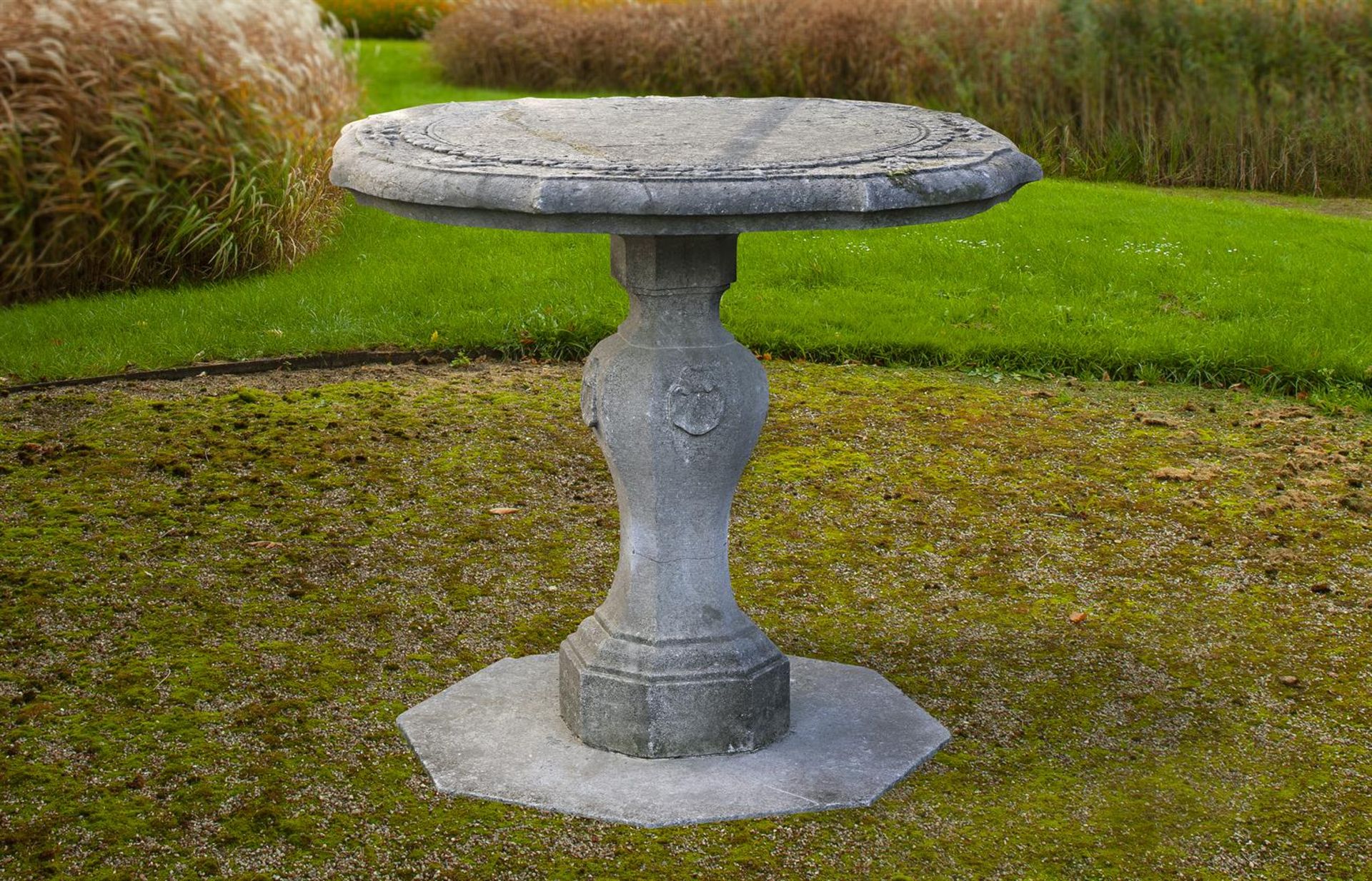 ‡ A DUTCH CARVED BLUESTONE GARDEN CENTRE TABLE