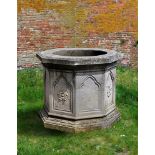 ‡ A CARVED LIMESTONE WELLHEAD