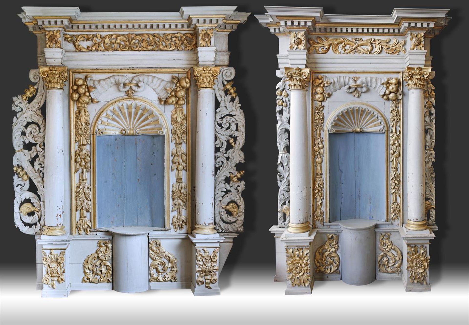 ‡ A NEAR PAIR OF CONTINENTAL CARVED PAINTED AND PARCEL GILT WOOD ARCHITECTURAL INTERIOR PANELS