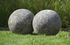 Ω A LARGE PAIR OF LIMESTONE ORNAMENTAL SPHERES