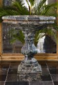 ‡ A CARVED VARIEGATED GREEN MARBLE BASIN OR CISTERN