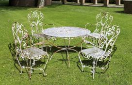 Ω A SUITE OF WHITE PAINTED WROUGHT IRON GARDEN FURNITURE