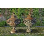 ‡ A PAIR OF ORNATE CAST IRON GARDEN URNS AND COVERS