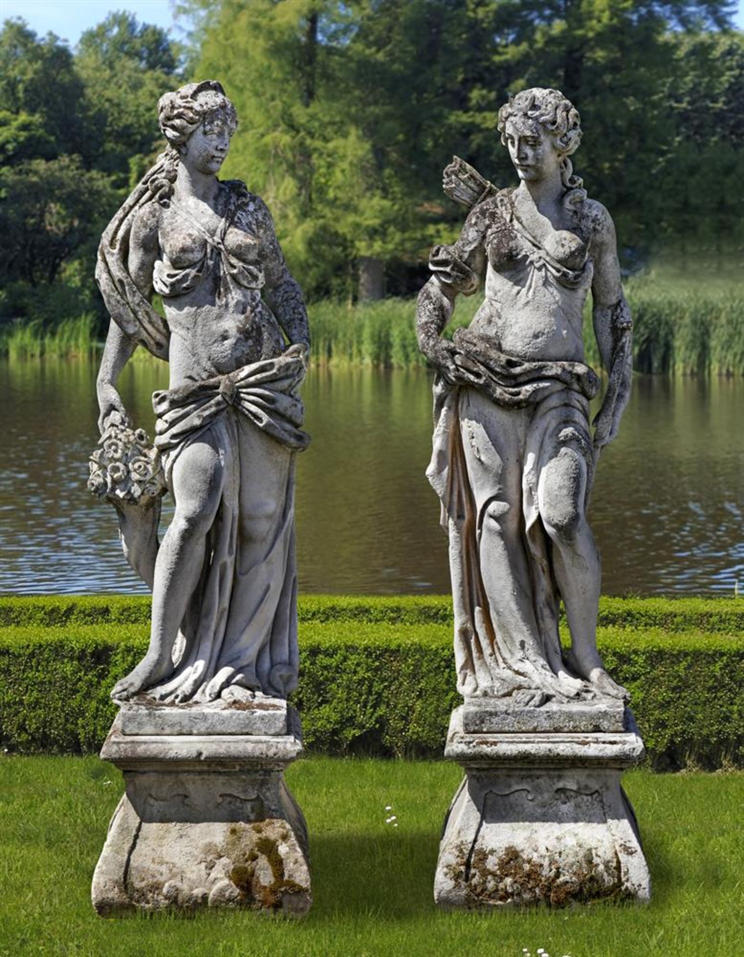 ‡ A PAIR OF SCULPTED LIMESTONE MODELS OF FLORA AND DIANA