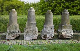 ‡ A SET OF FOUR CARVED LIMESTONE PILLARS OR DRIVEWAY OR BORDER MARKERS