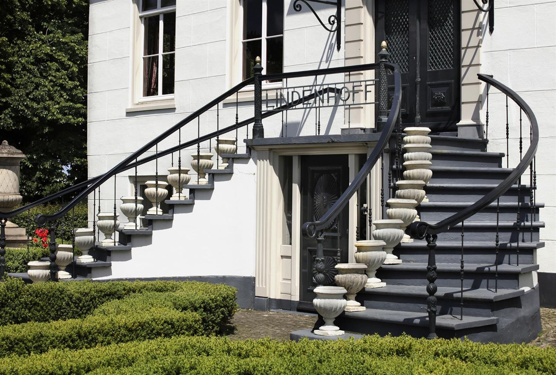 ‡ A SUITE OF EIGHTEEN PAINTED LIMESTONE PLANTERS