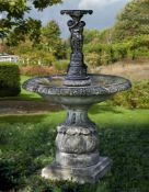 ‡ A CARVED LIMESTONE AND BRONZE MOUNTED FOUNTAIN