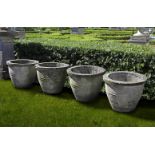 Ω A SET OF FOUR COMPOSITION STONE GARDEN PLANTERS