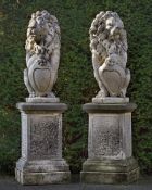 Ω A PAIR OF SCULPTED LIMESTONE MODELS OF HERALDIC LIONS