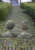 ‡ A PAIR OF CARVED LIMESTONE PIER FINIALS