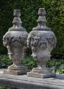 ‡ A PAIR OF CARVED LIMESTONE PIER FINIALS