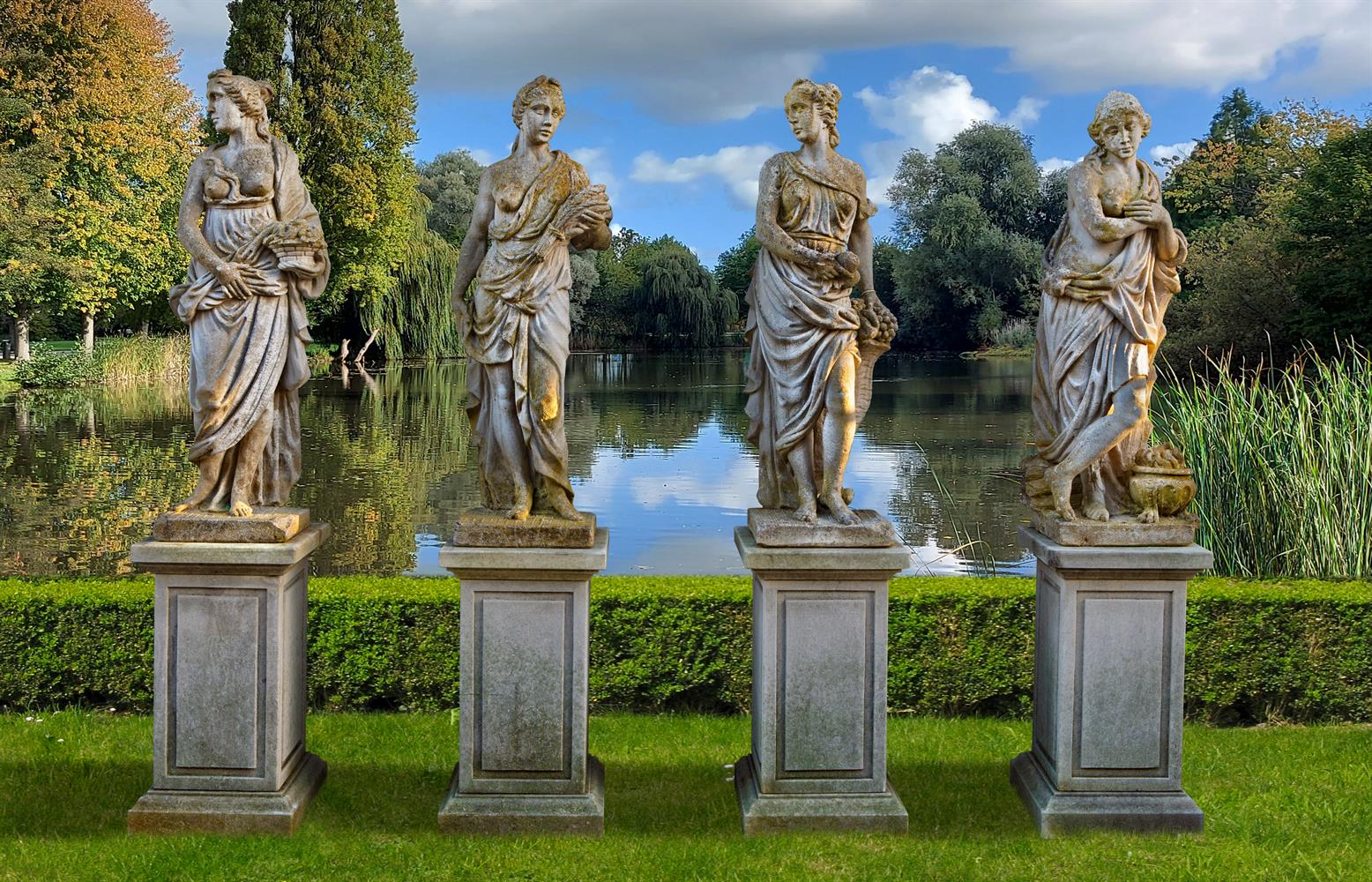 Ω A SET OF FOUR COMPOSITION STONE MODELS OF MAIDENS REPRESENTING THE FOUR SEASONS