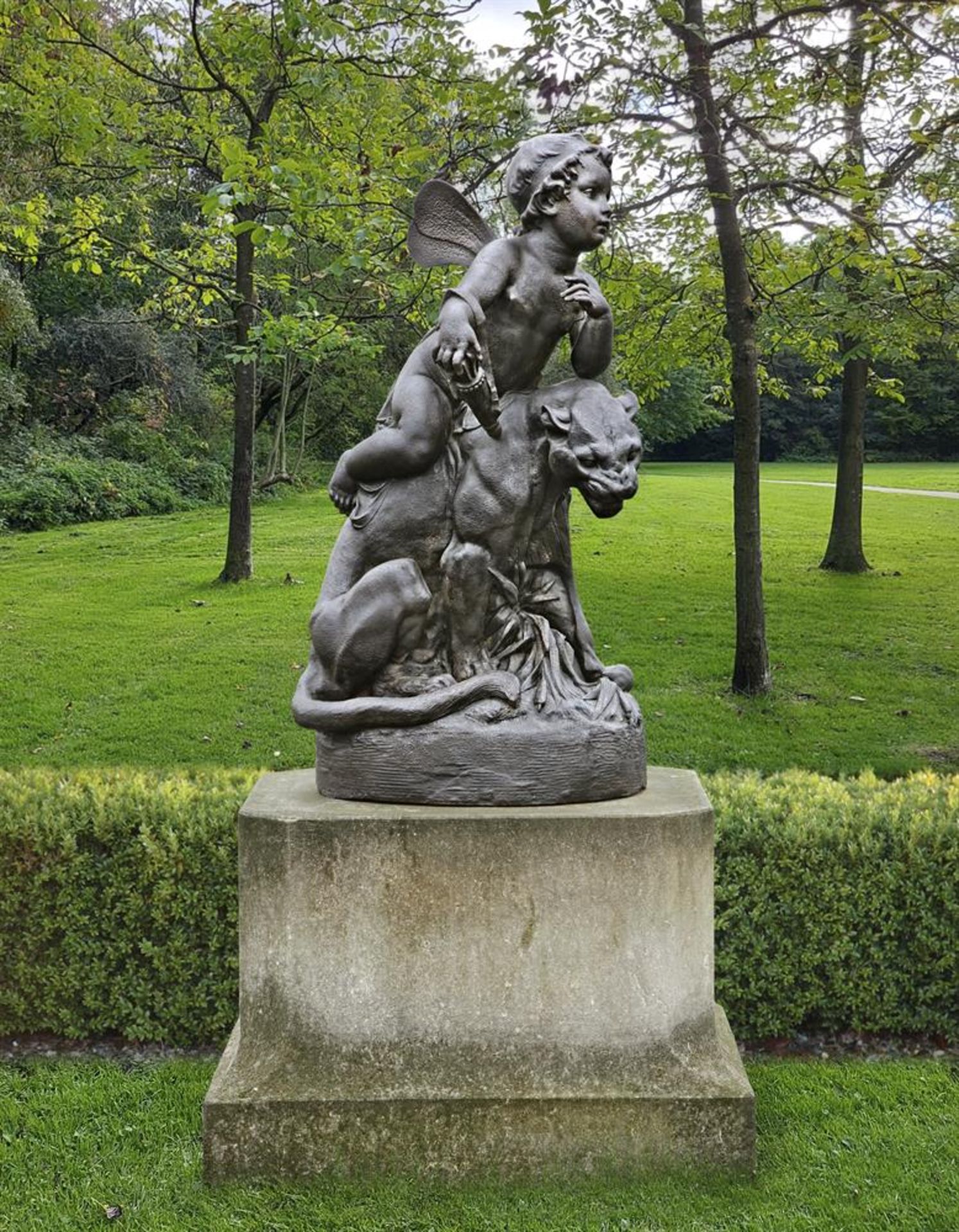 ‡ MANNER OF GIOVANNI MARIA BENZONI, A CAST IRON GROUP REPRESENTING CUPID SEATED ON A PANTHER