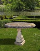 Ω A CARVED LIMESTONE CIRCULAR GARDEN TABLE