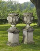 ‡ A PAIR OF LIMESTONE PLANTERS ON PEDESTALS