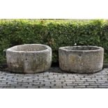 ‡ A PAIR OF SIMILAR CIRCULAR CARVED LIMESTONE TROUGHS