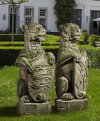 ‡ A PAIR SCULPTED SANDSTONE PIER FINIALS CARVED AS HERALDIC LIONS