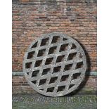 Ω A CARVED STONE WELL GRATE