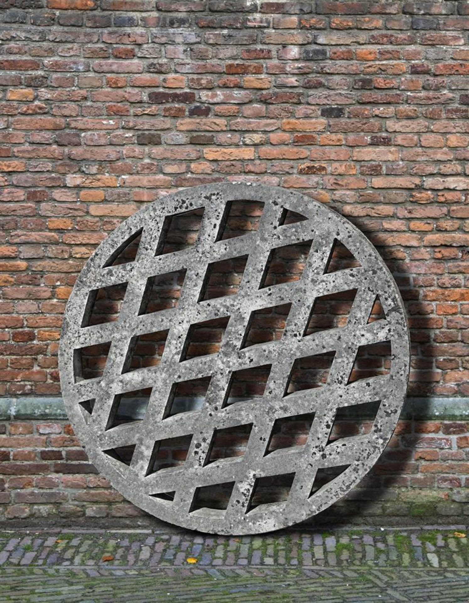 Ω A CARVED STONE WELL GRATE